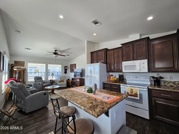 a kitchen with a stove a sink a refrigerator and cabinets