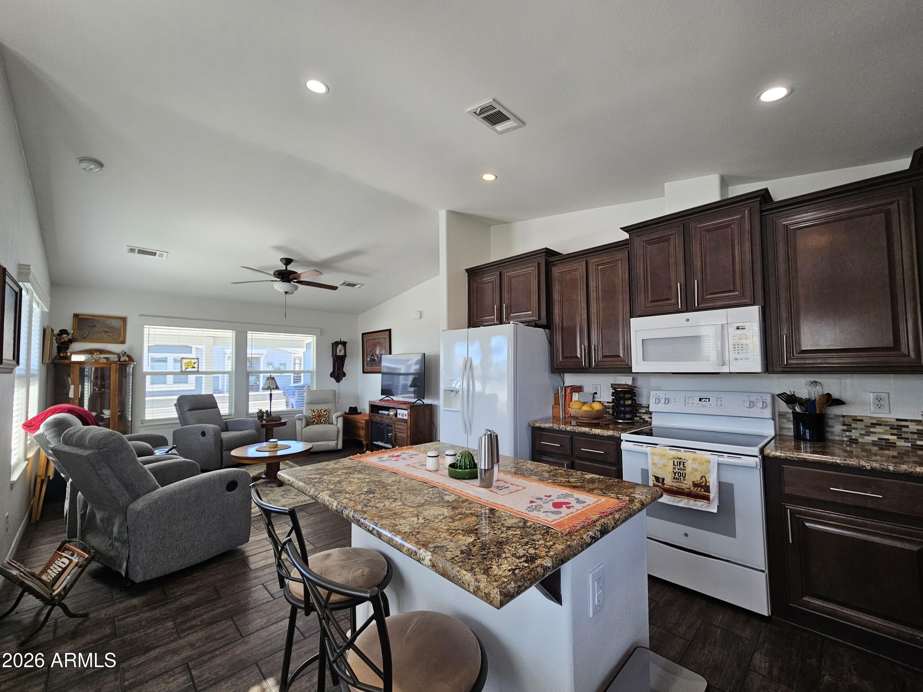 650 North Hawes Road, Unit 3202 Mesa, AZ 85207 - Photo 10 of 35 a kitchen with a stove a sink a refrigerator and cabinets