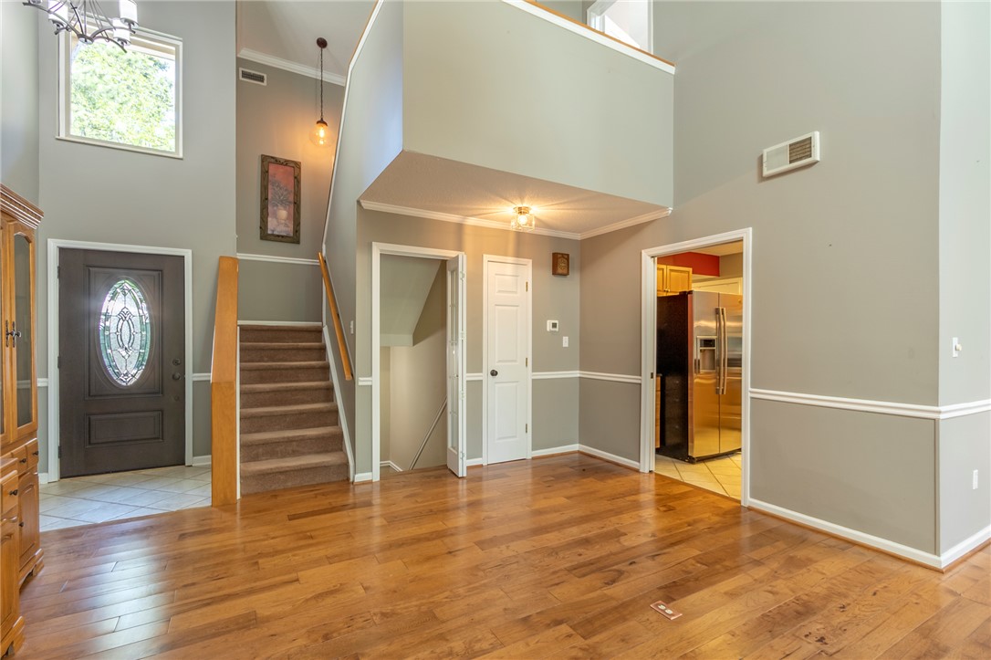 1302 Leeward Road Anderson, SC 29625 - Photo 11 of 50 An inviting entry showcases gleaming hardwood floors and a striking staircase.