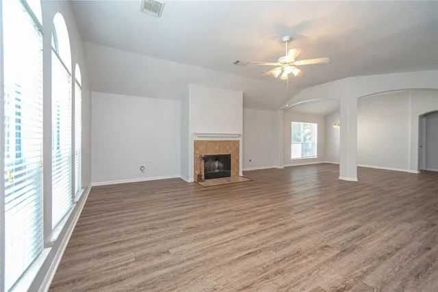 a view of a livingroom with wooden floor and a ceiling fan