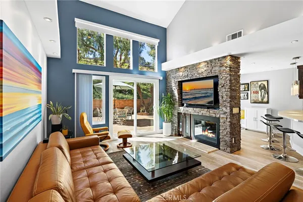 a living room with fireplace furniture and a flat screen tv