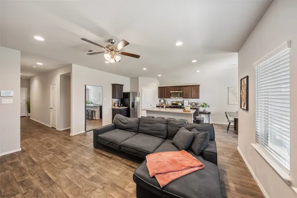a living room with furniture and kitchen view
