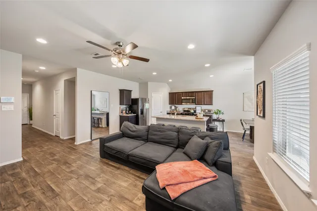a living room with furniture and kitchen view