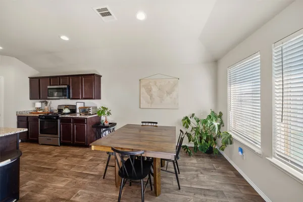 a kitchen with a table and chairs in it