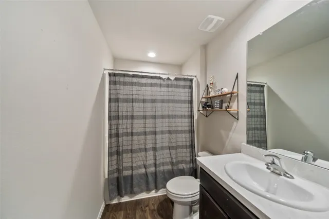 a bedroom with a bed and a window with bathroom