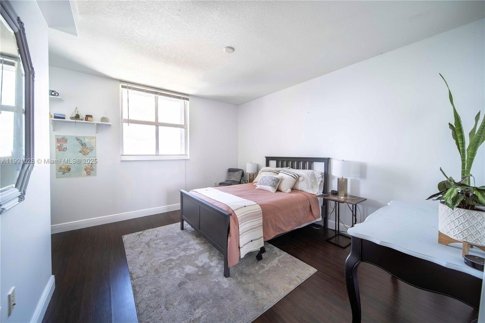 1250 South Miami Avenue, Unit 2201 Miami, FL 33130 - Photo 15 of 30 a bedroom with a bed and a potted plant