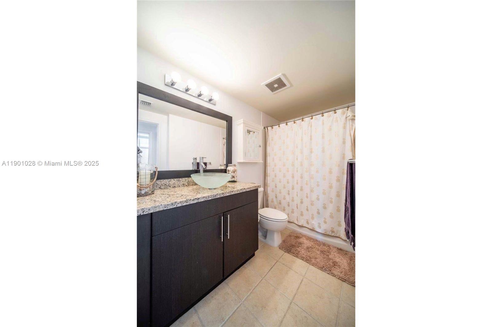 1250 South Miami Avenue, Unit 2201 Miami, FL 33130 - Photo 18 of 30 a bathroom with a sink a mirror and a bathtub