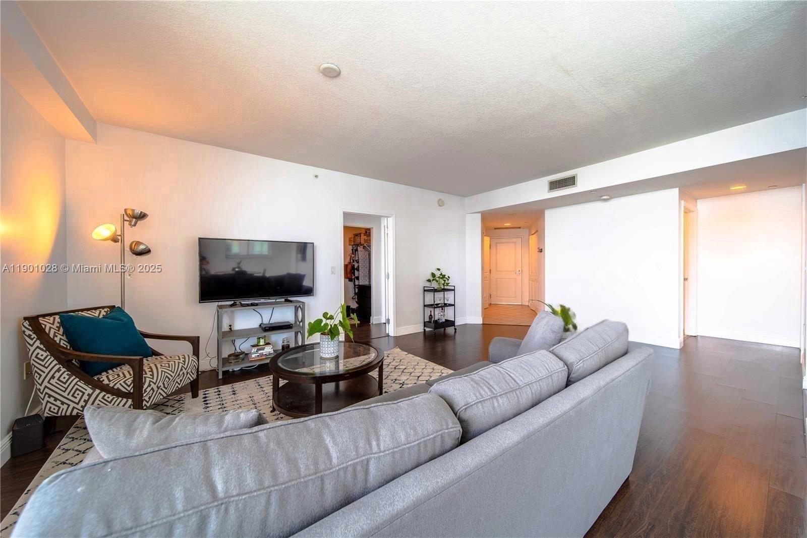 1250 South Miami Avenue, Unit 2201 Miami, FL 33130 - Photo 6 of 30 a living room with furniture and a flat screen tv