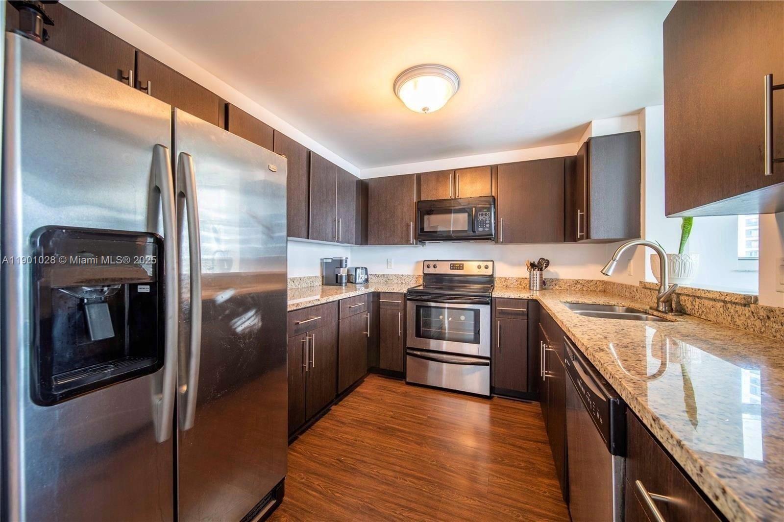 1250 South Miami Avenue, Unit 2201 Miami, FL 33130 - Photo 10 of 30 a kitchen with stainless steel appliances granite countertop a refrigerator a stove and a sink