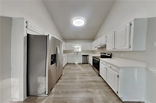 a large kitchen with white cabinets