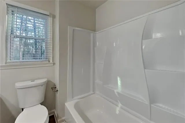 a bathroom with a toilet and shower