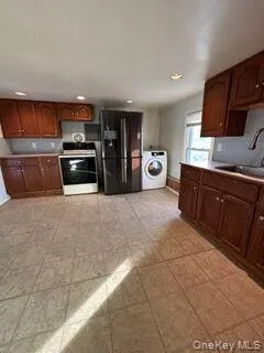a kitchen with stainless steel appliances a sink a stove top oven a counter space and cabinets