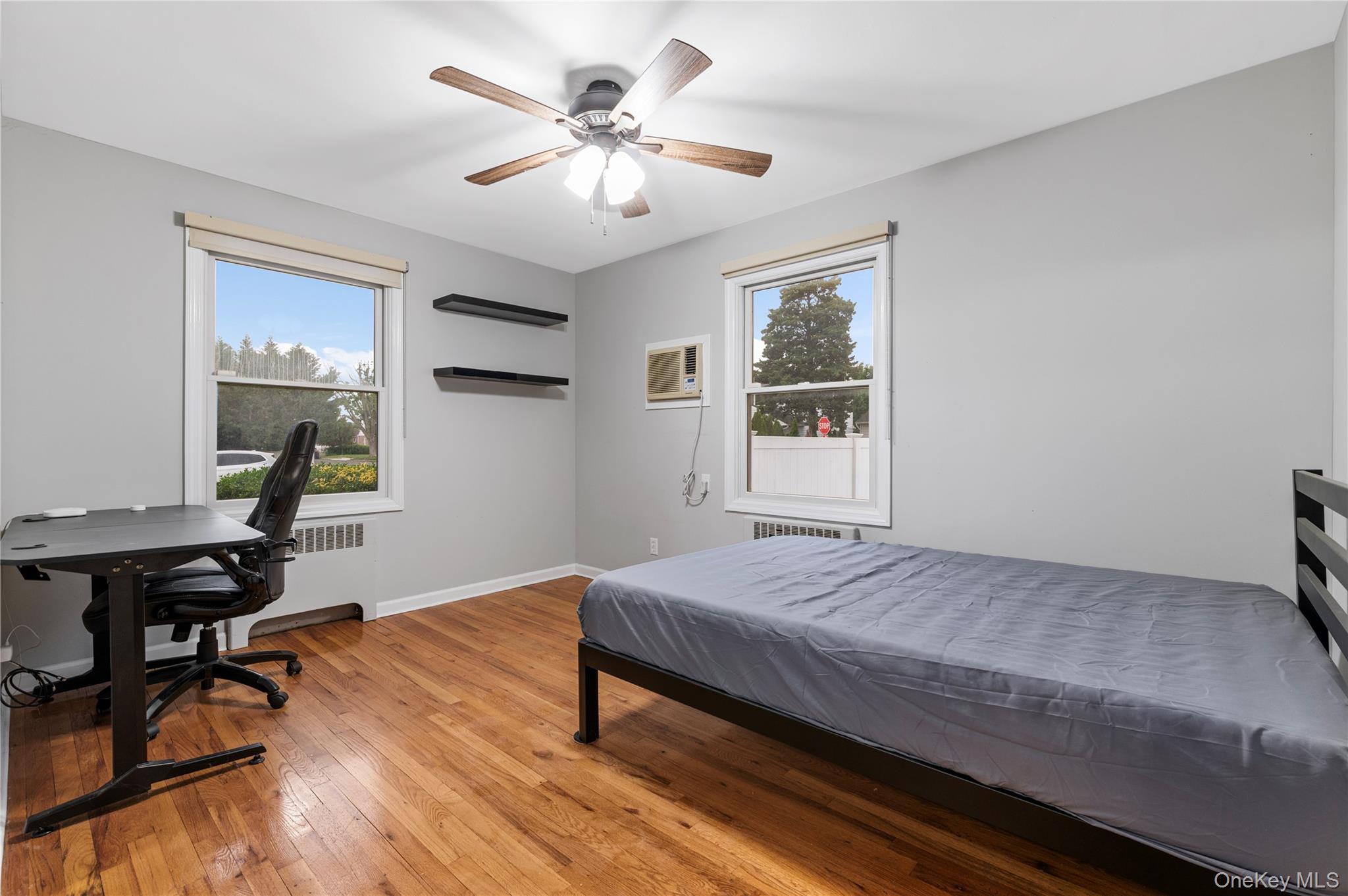 3 Cheshire Road Bethpage, NY 11714 - Photo 10 of 26 a bedroom with a bed dresser and a window