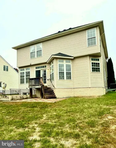 a house view with swimming pool in front of it