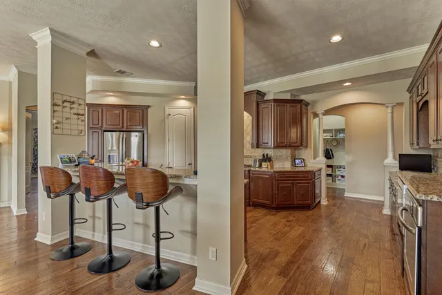 a bathroom with a granite countertop sink a toilet and a mirror