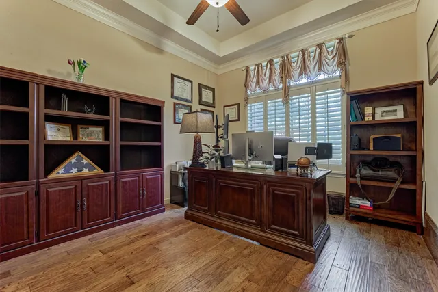 a large bed sitting in a bedroom and painting on the wall