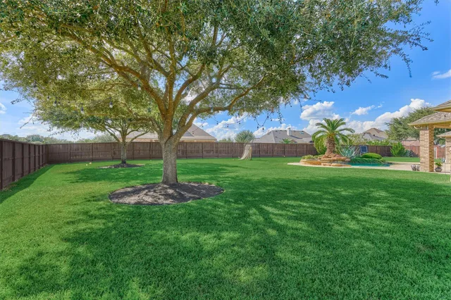 a view of a dining room with furniture a chandelier and wooden floor
