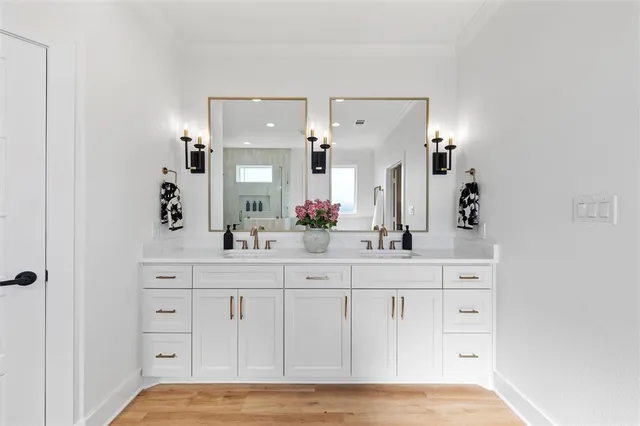 a spacious bathroom with a double vanity sink and mirror