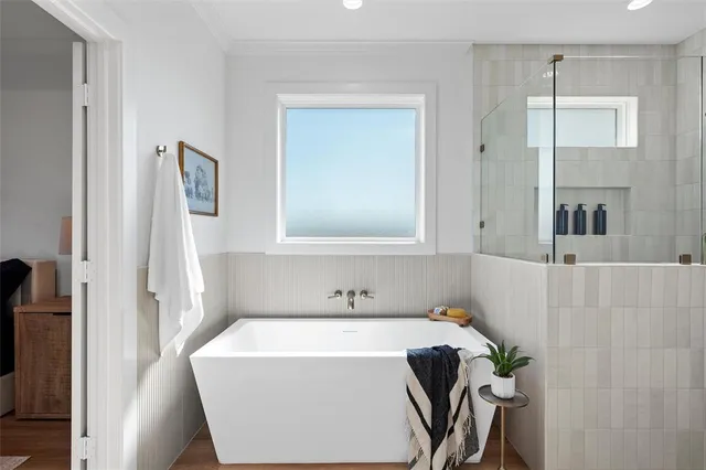 a bathroom with a tub and shower