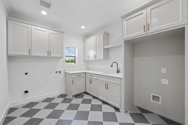 a kitchen with a checkered floor and white cabinets
