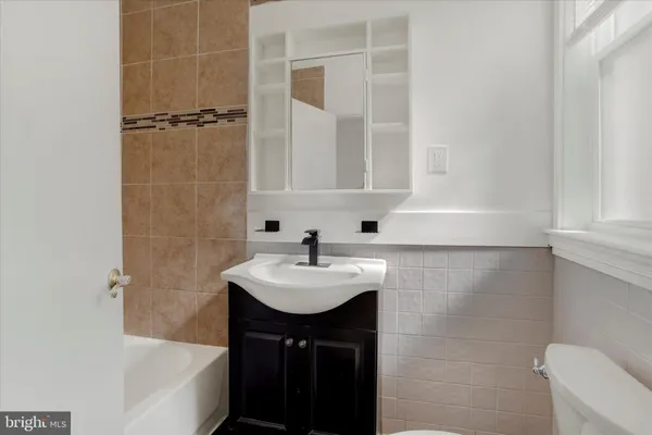 a bathroom with a sink a bathtub and a shower