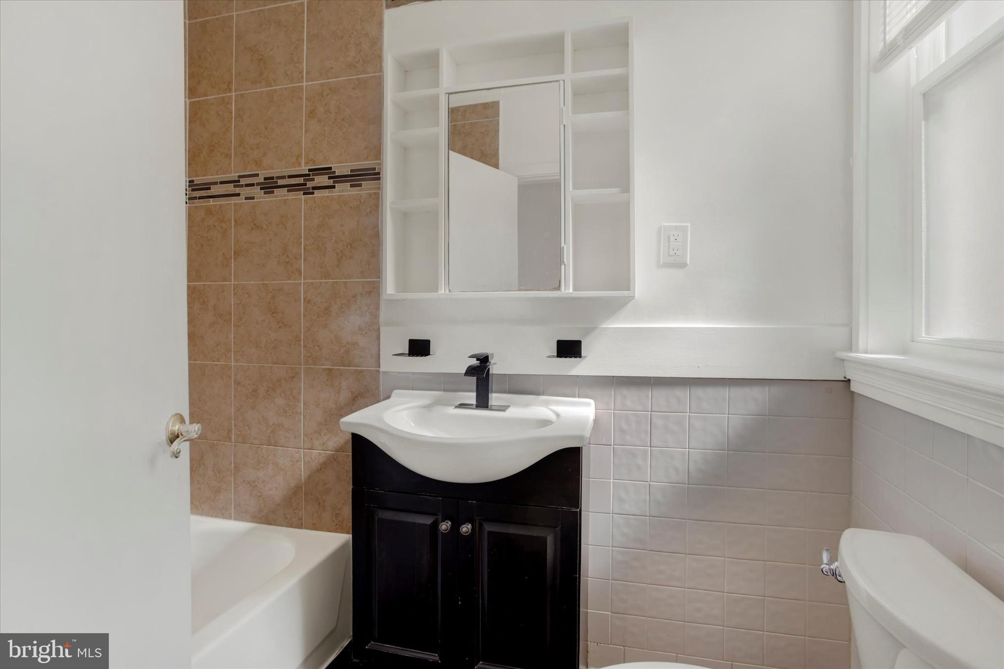 637 M Street Northeast Washington, DC 20002 - Photo 12 of 15 a bathroom with a sink a bathtub and a shower