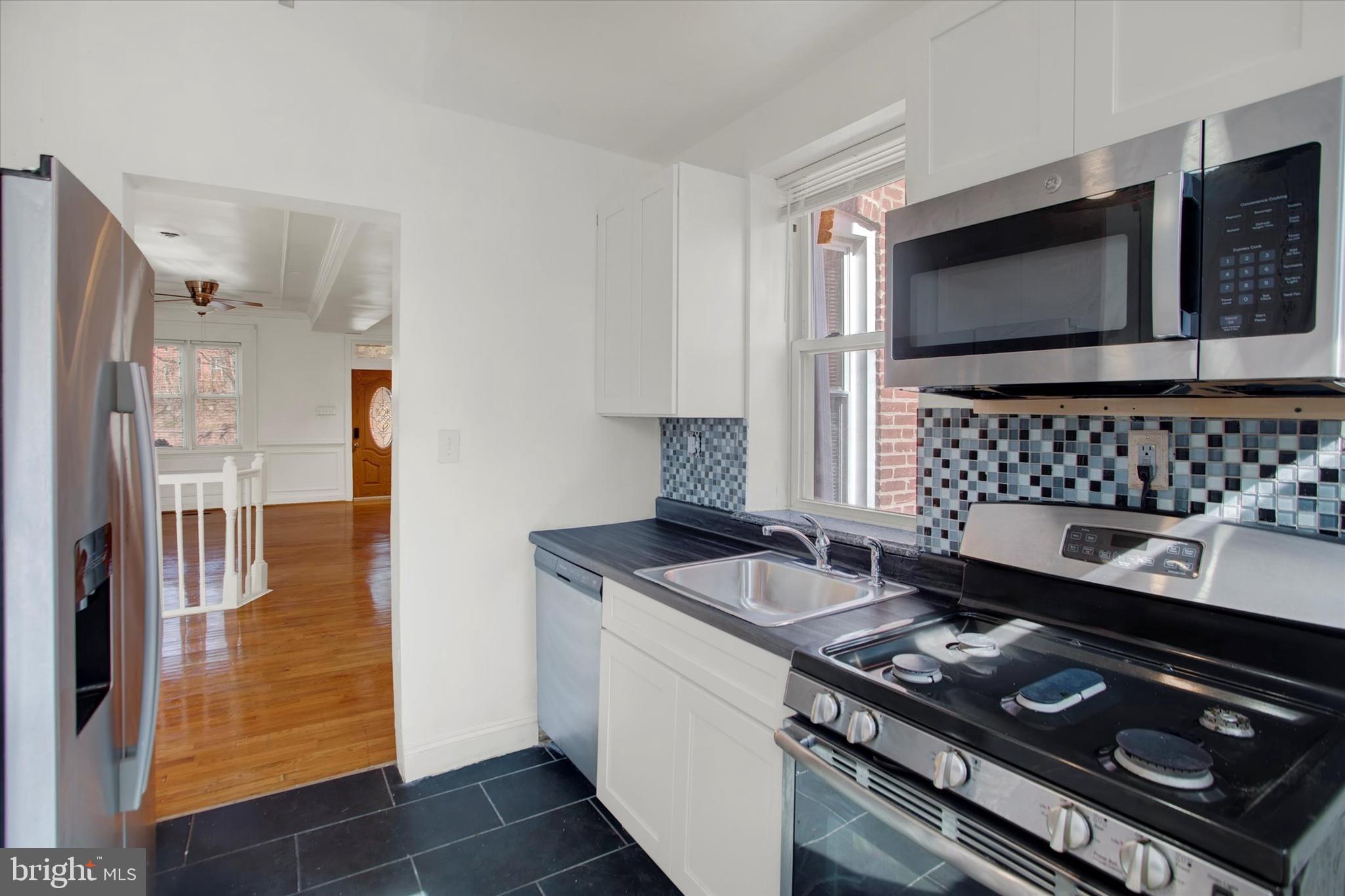 637 M Street Northeast Washington, DC 20002 - Photo 6 of 15 a kitchen with a stove and a microwave