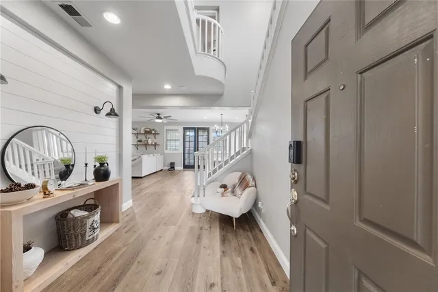 a hallway with wooden floor a rug and a stove