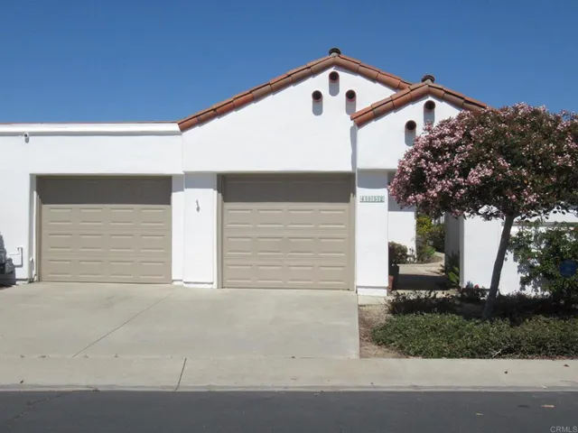 a front view of a house with a yard garage and outdoor seating
