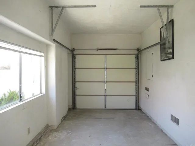 a view of a house with a small yard and plants
