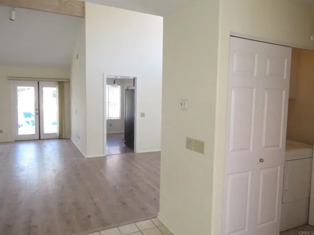 a kitchen with a refrigerator sink and cabinets