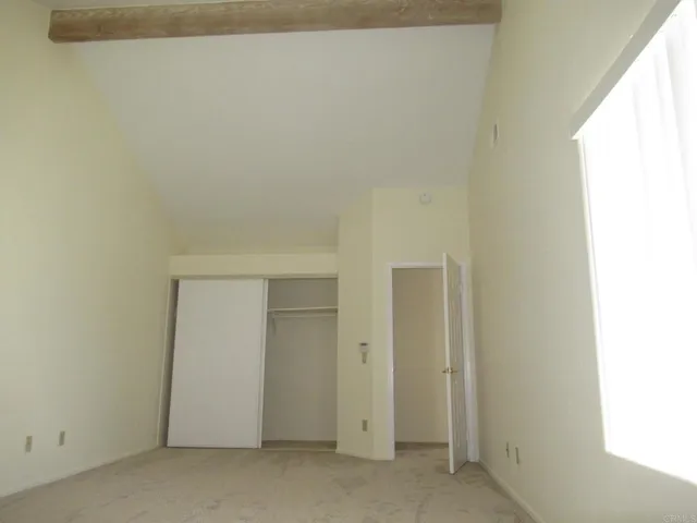 a front view of a house with a garden and trees