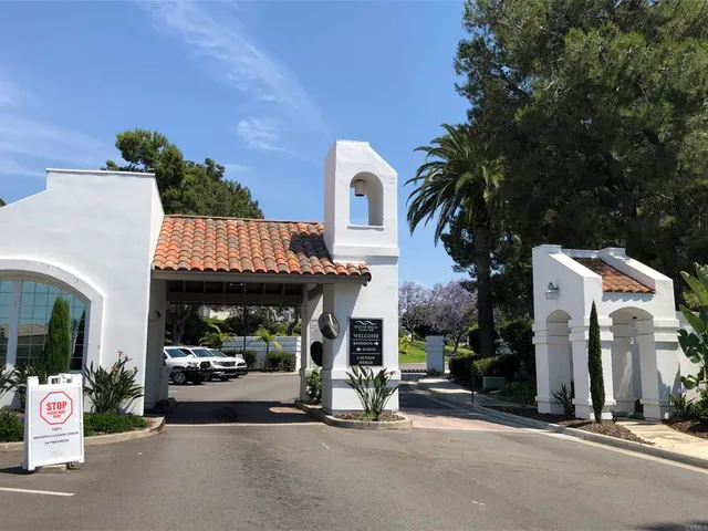 a view of a hallway with chandelier and wooden floor