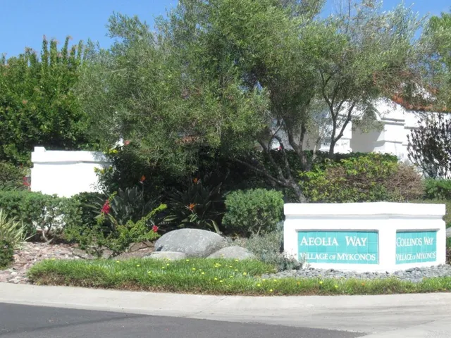 a view of a white house with a street