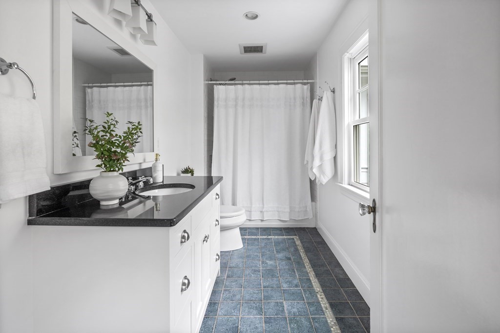 43 Bertwell Road Lexington, MA 02420 - Photo 20 of 41 a bathroom with a sink a toilet a mirror and shower