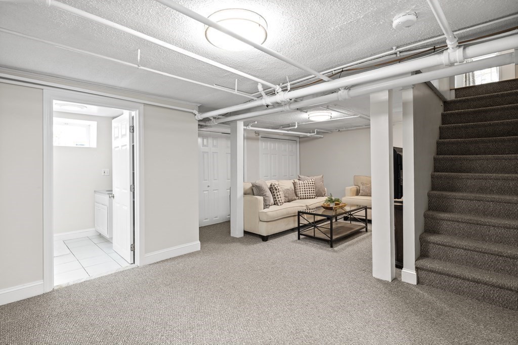 43 Bertwell Road Lexington, MA 02420 - Photo 32 of 41 a living room with furniture and a glass door shower