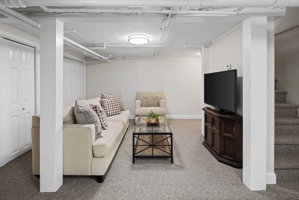 43 Bertwell Road Lexington, MA 02420 - Photo 33 of 41 a living room with furniture and a flat screen tv