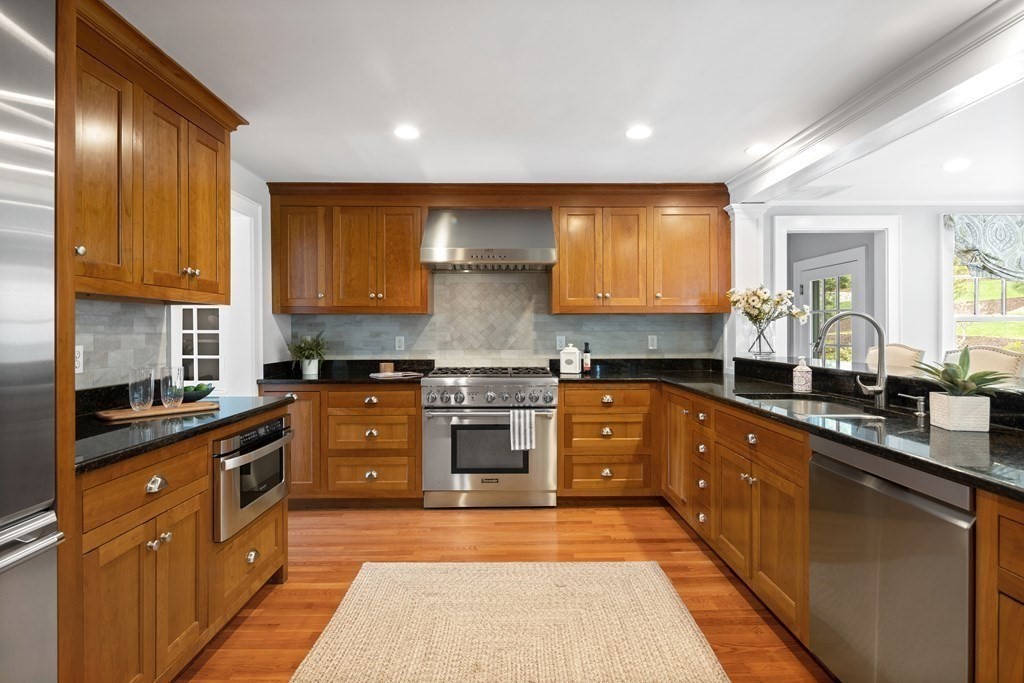 43 Bertwell Road Lexington, MA 02420 - Photo 10 of 41 a kitchen with stainless steel appliances granite countertop wooden cabinets a stove top oven a sink and dishwasher