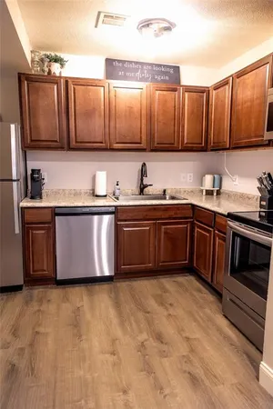 a kitchen with stainless steel appliances granite countertop a sink and cabinets