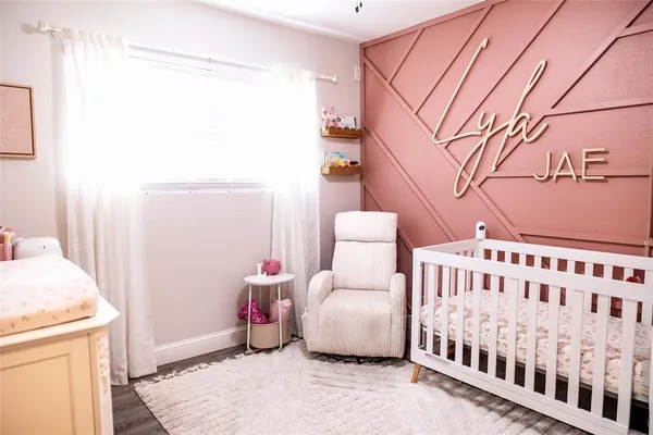 a bedroom with furniture and wooden floor