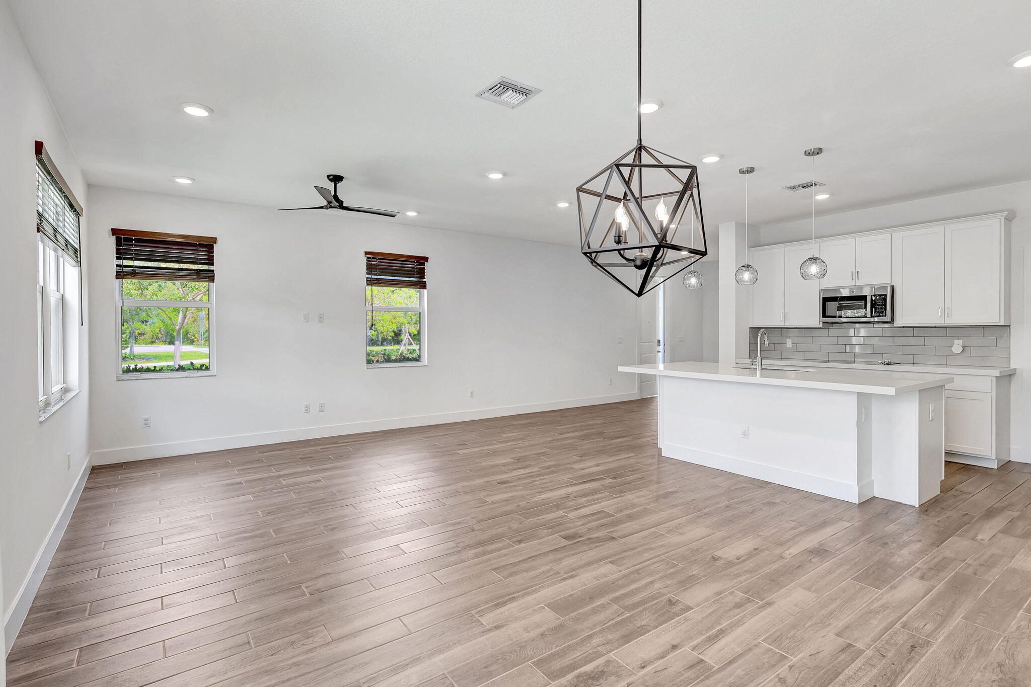 229 Preserve Trail South Stuart, FL 34994 - Photo 18 of 60 a view of a kitchen with a sink dishwasher a kitchen island with wooden floor and cabinets