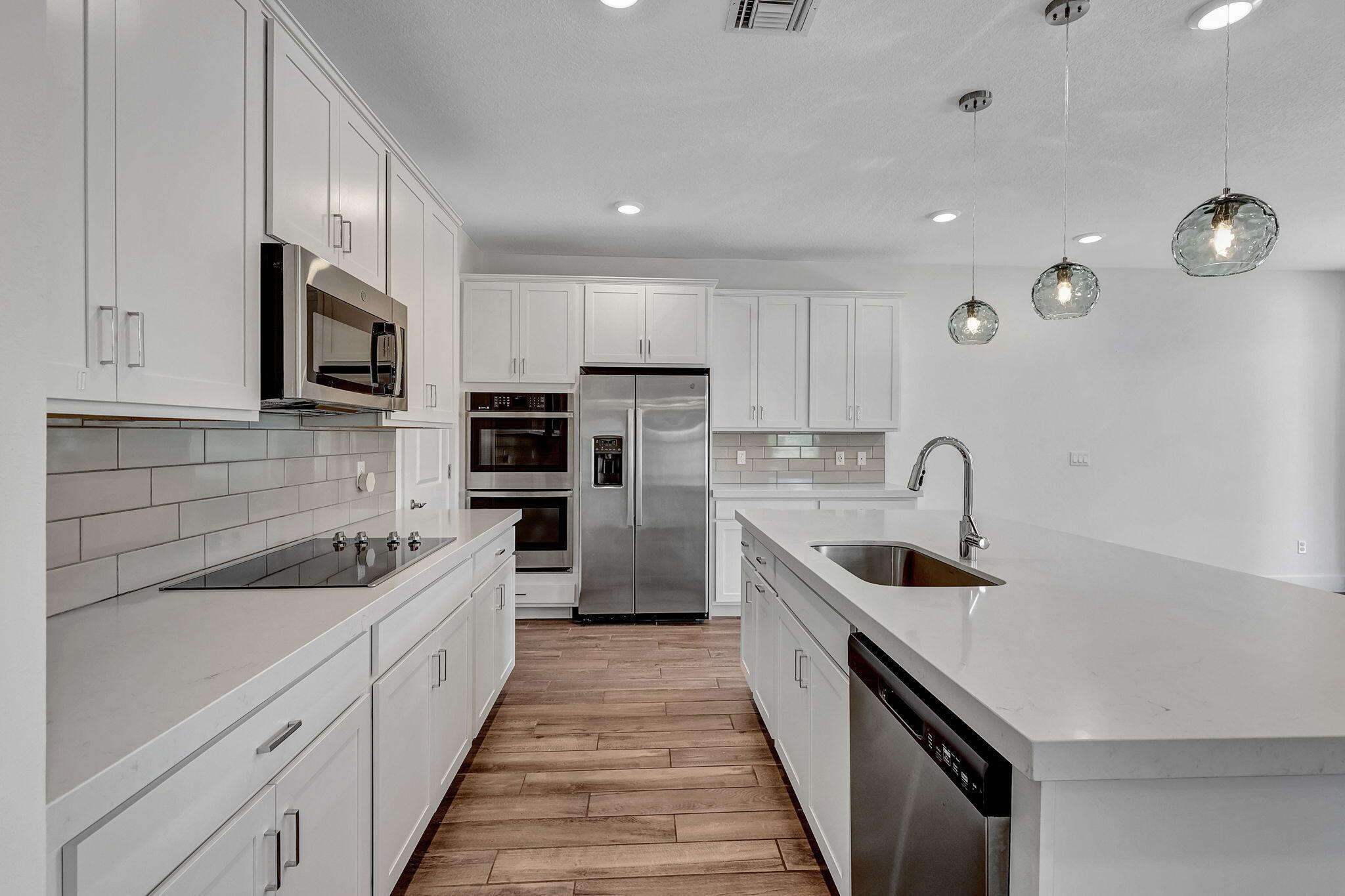 229 Preserve Trail South Stuart, FL 34994 - Photo 20 of 60 a kitchen with stainless steel appliances sink a microwave and cabinets