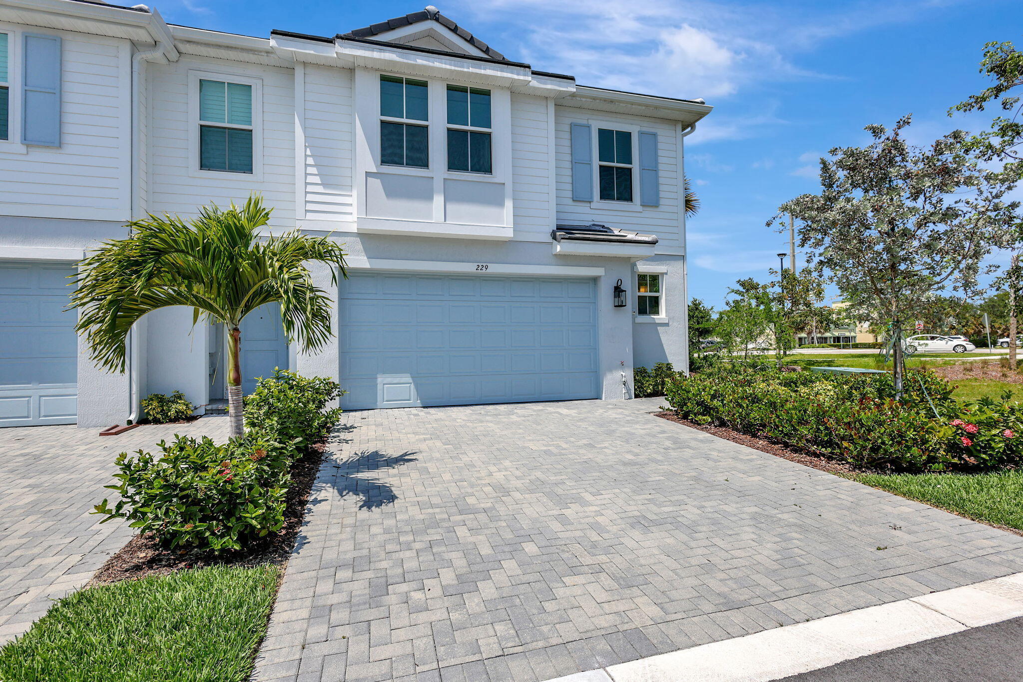 229 Preserve Trail South Stuart, FL 34994 - Photo 3 of 60 a front view of a house with a yard and potted plants