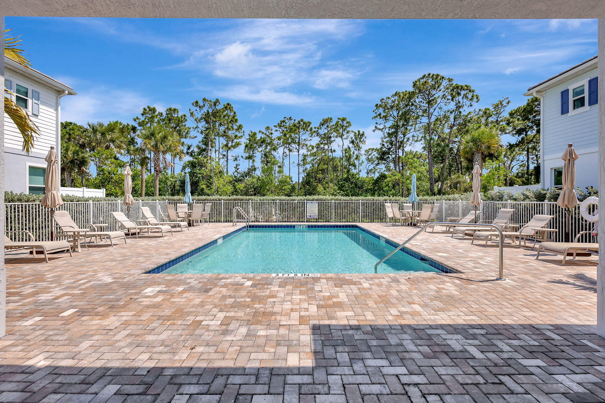 229 Preserve Trail South Stuart, FL 34994 - Photo 58 of 60 a view of a swimming pool with an outdoor space and seating area