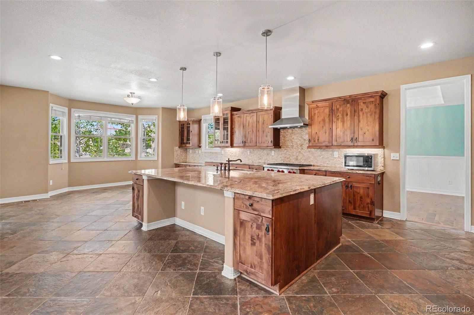 791 Elk Rest Road Evergreen, CO 80439 - Photo 10 of 46 a kitchen with a stove sink and cabinets