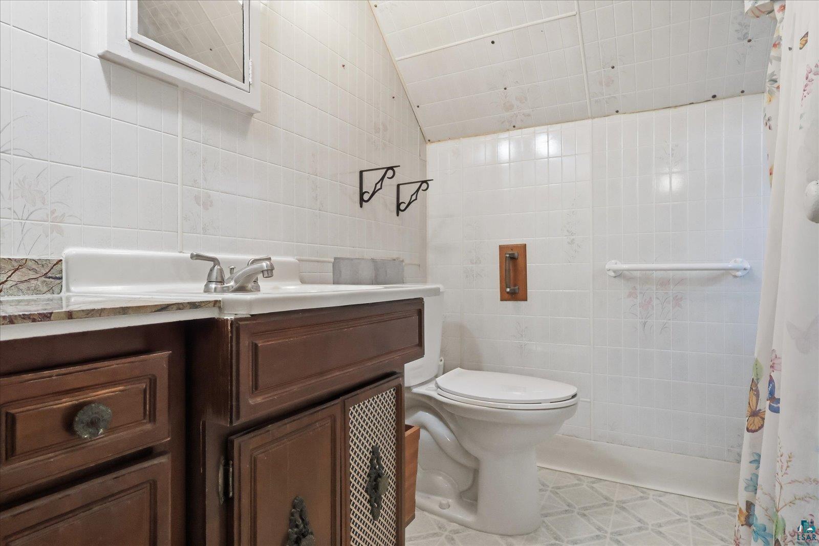 5192 Lavaque Junction Road Hermantown, MN 55811 - Photo 22 of 34 Bathroom featuring a wood-finish vanity with a white countertop and chrome faucet