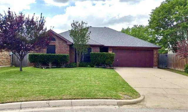 a view of backyard of house with green space