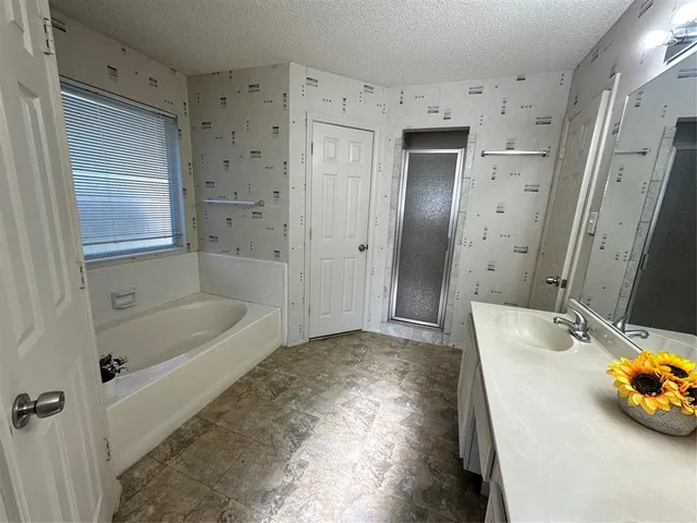 a bathroom with a tub sink and a mirror