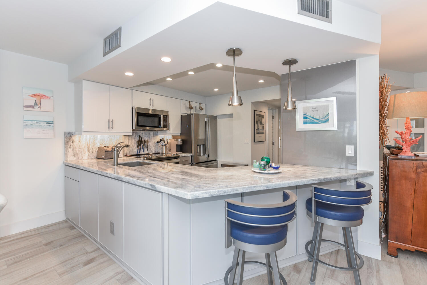 1605 Highway 1, Unit B302 Jupiter, FL 33477 - Photo 14 of 47 a kitchen with kitchen island a sink and a stove