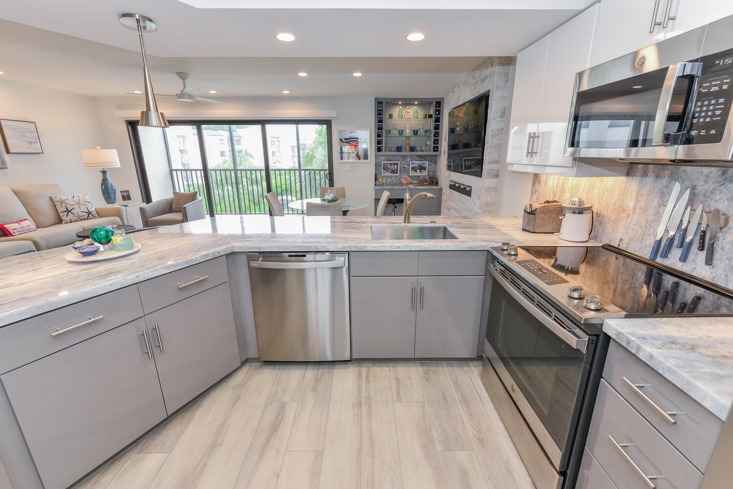 1605 Highway 1, Unit B302 Jupiter, FL 33477 - Photo 26 of 47 a kitchen with a sink stove and cabinets